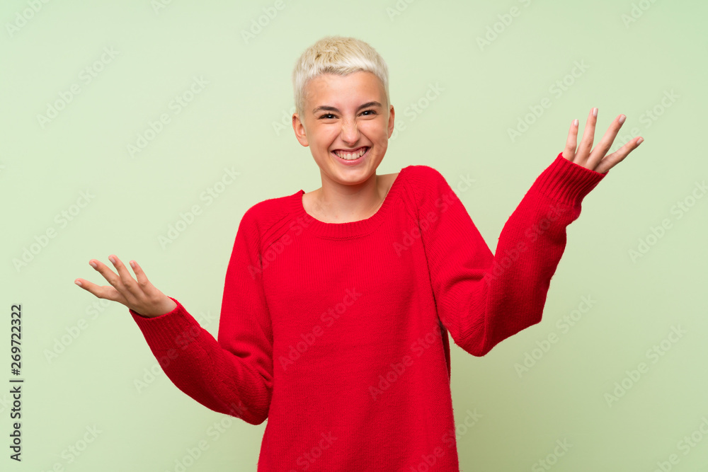 Teenager girl with white short hair over green wall smiling Teenager girl with white short hair over green wall smiling