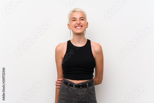 Cuadro en lienzo Teenager girl with short hair over white wall laughing