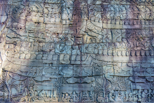 Famous bas reflief carved in the wall of Angkor Wat temple  world heritage and most visited tourist site  Cambodia. Details  close up of epic battles rock carving.