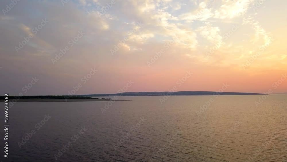 High flying drone at sunset above sea with panoramic forward facing view of island Pasman in Croatia in background. High flying drone at sunset above sea with panoramic forward facing view of island Pasman in Croatia in background.