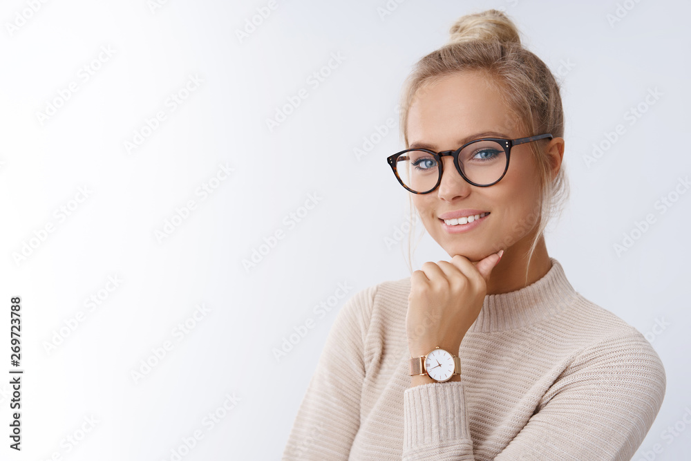 Close-up shot of smiling attractive happy and successful european blond female in sweater watch and glasses grinning expressing confidence, looking accomlished and daring at camera with sassy smile