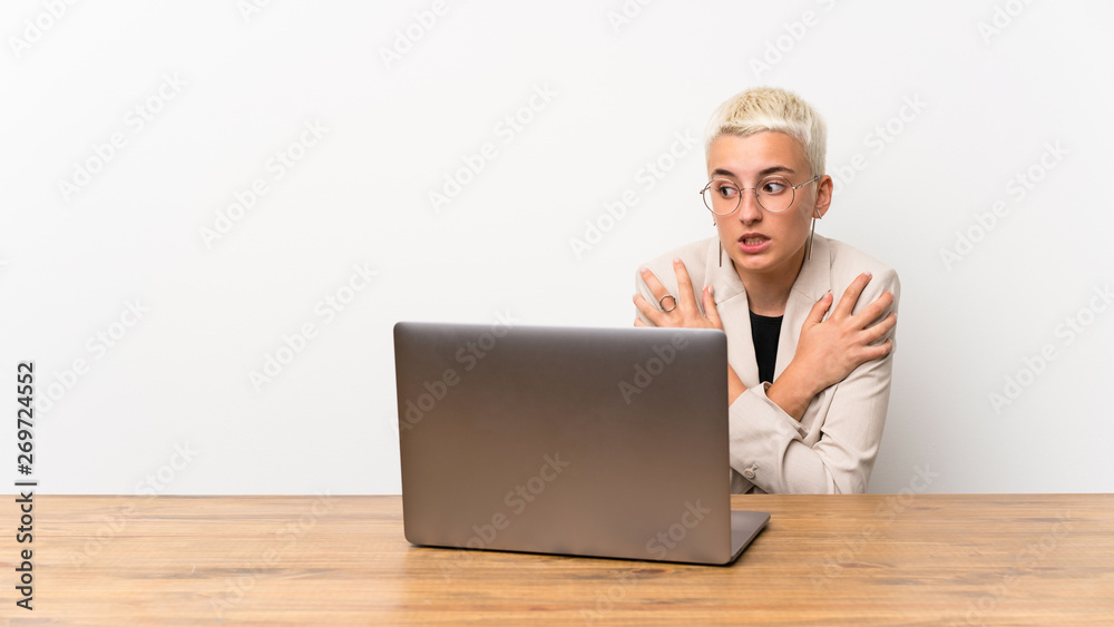 Teenager girl with short hair with a laptop freezing Teenager girl with short hair with a laptop freezing