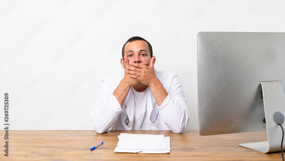 Doctor Colombian man covering mouth with hands Doctor Colombian man covering mouth with hands