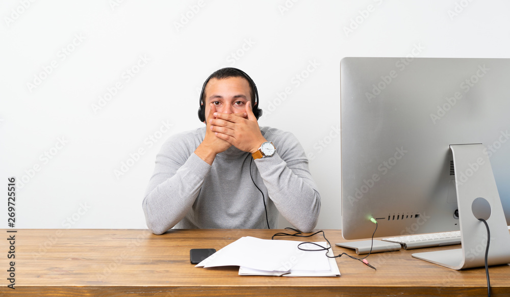 Telemarketer Colombian man covering mouth with hands Telemarketer Colombian man covering mouth with hands