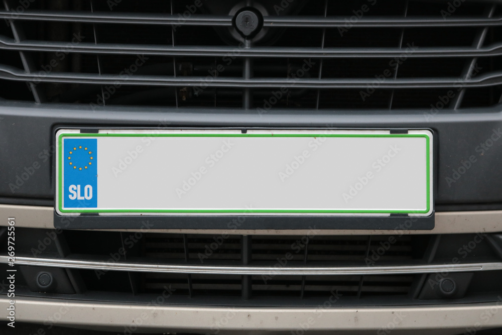 Empty License plate in the front of a white car Empty License plate in the front of a white car