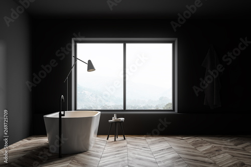 Gray bathroom with tub and window