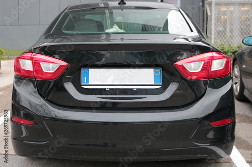 Empty License plate on the back of a black car