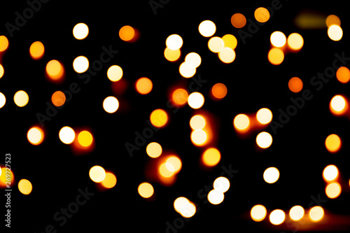 Unfocused abstract gold bokeh on black background. defocused and blurred many round light