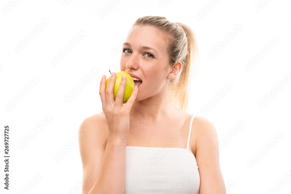 Young blonde woman over isolated white background with an apple Young blonde woman over isolated white background with an apple