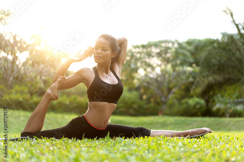 girl doing yoga at sunset in Thailand in the park