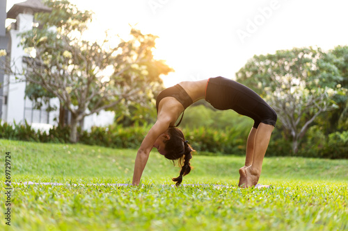 girl doing yoga at sunset in Thailand in the park