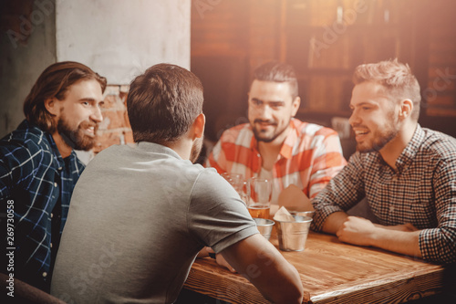 Billede på lærred Drinking craft beer from glasses in pub, group of male friends