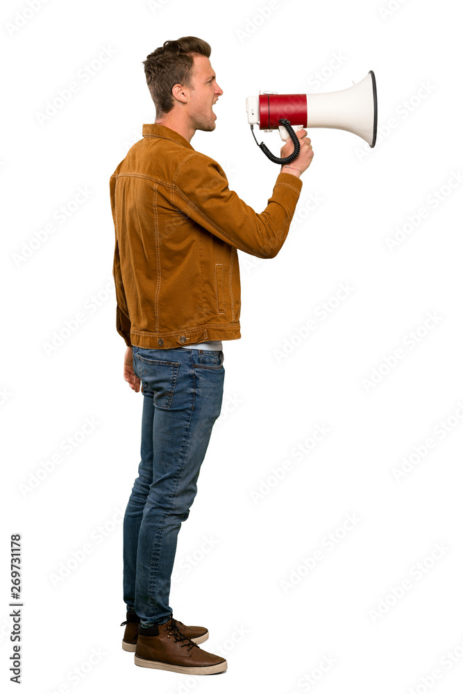 Blonde handsome man shouting through a megaphone Blonde handsome man shouting through a megaphone