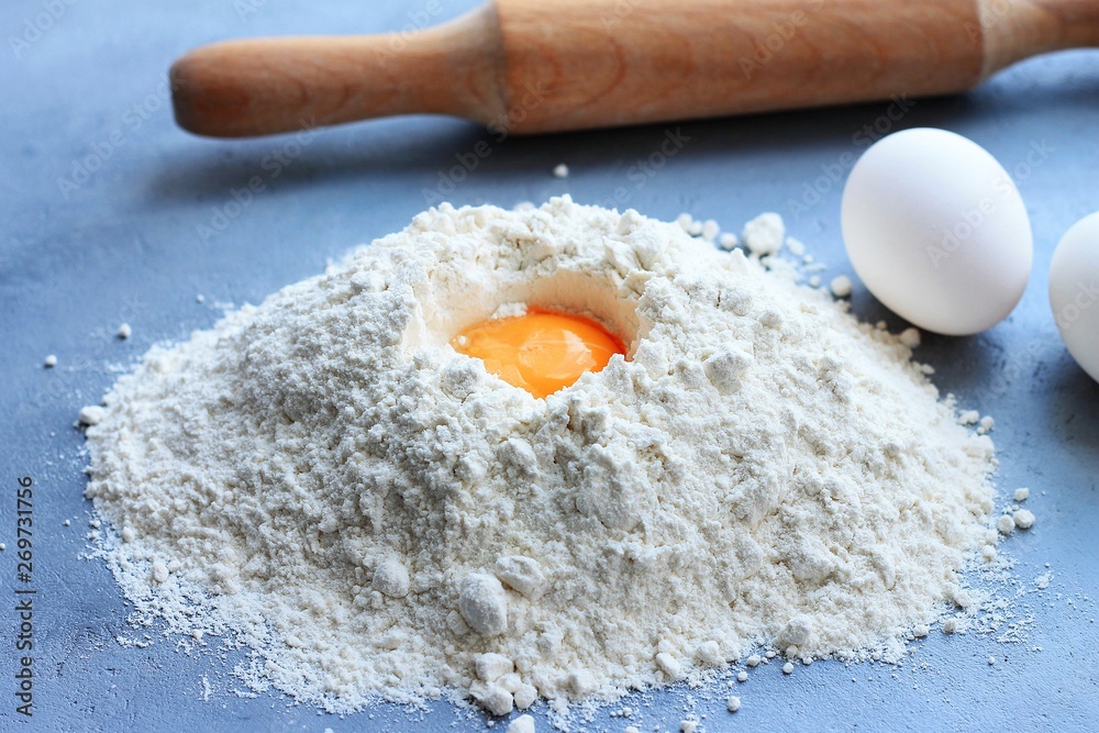 Preparation of dough, flour, eggs and rolling pin on gray background. Preparation of dough, flour, eggs and rolling pin on gray background.