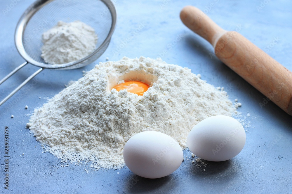 Preparation of dough, flour, eggs and rolling pin on gray background. Preparation of dough, flour, eggs and rolling pin on gray background.
