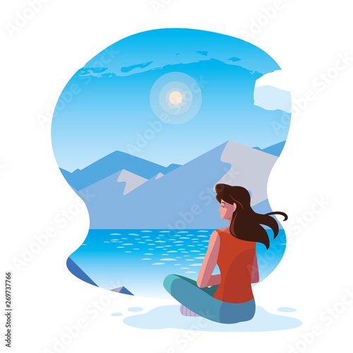 woman seated observing landscape with lake