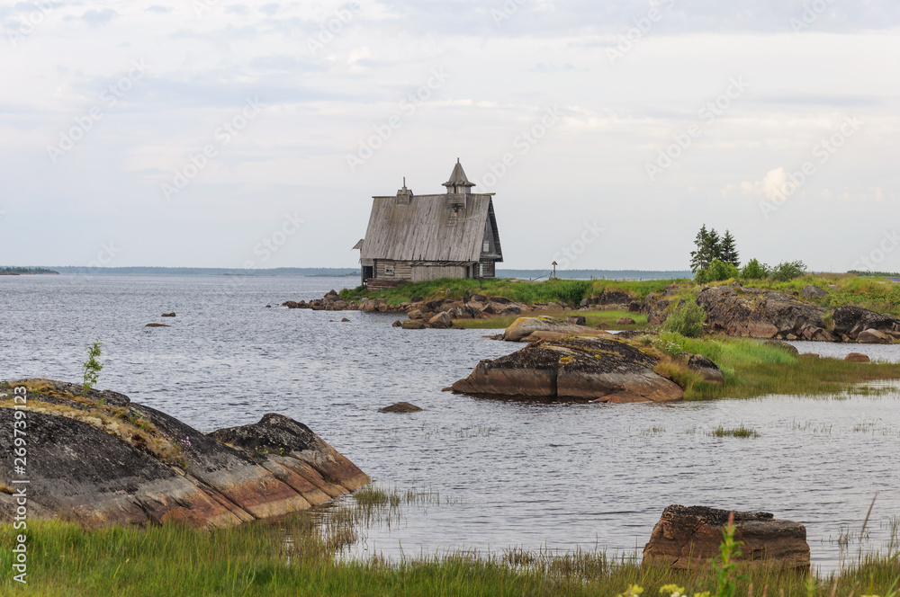 Rocky shore of the White Sea with old wooden church Rocky shore of the White Sea with old wooden church