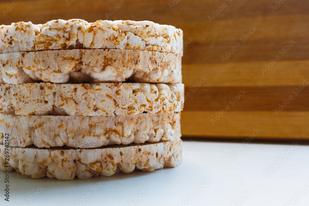 .Puffed rice snack breads lie on top of each other and form a tower. rice galettes. Rice Waffle on the wooden and background close-up shot.