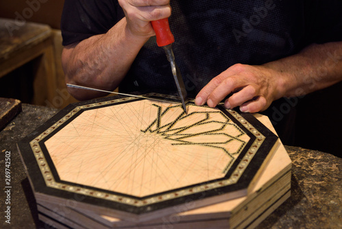 фотографія Craftsman working on inlaid platter in a Alhambra shop Granada