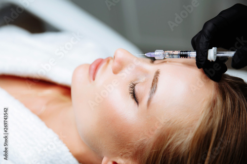 Portrait of female patient having modern noninvasive procedure of rhinoplasty,