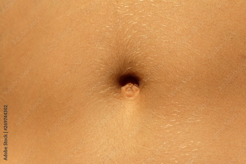 Closeup - navel of the stomach - belly button. Slim nude young woman belly.  Stock Photo | Adobe Stock