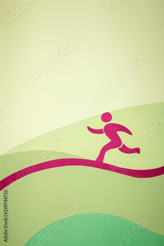 The image of a running man of pink color running along a curved line on a yellow-green background