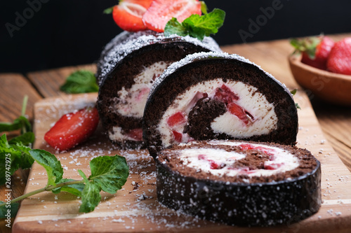 Recipe for biscuit rolls with strawberries decorated with fresh mint leaves.