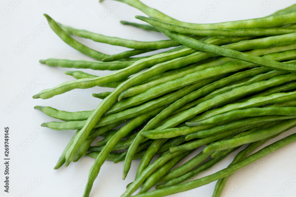 Bunch of green beans lying on a light table Bunch of green beans lying on a light table
