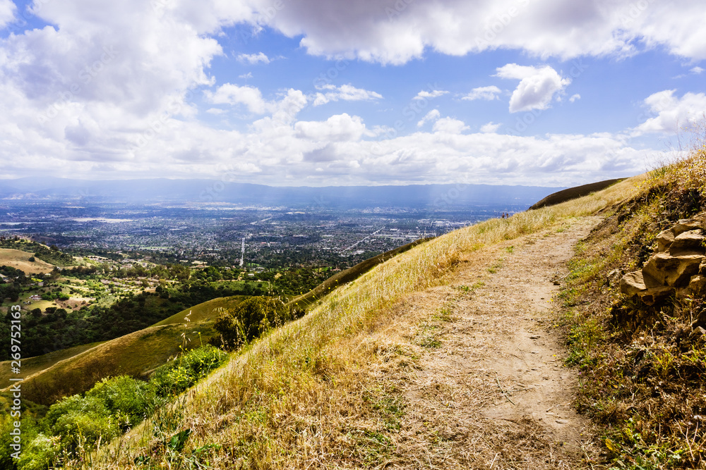 Hiking trail through the hills of south San Francisco bay area, San Jose visible in the background, California