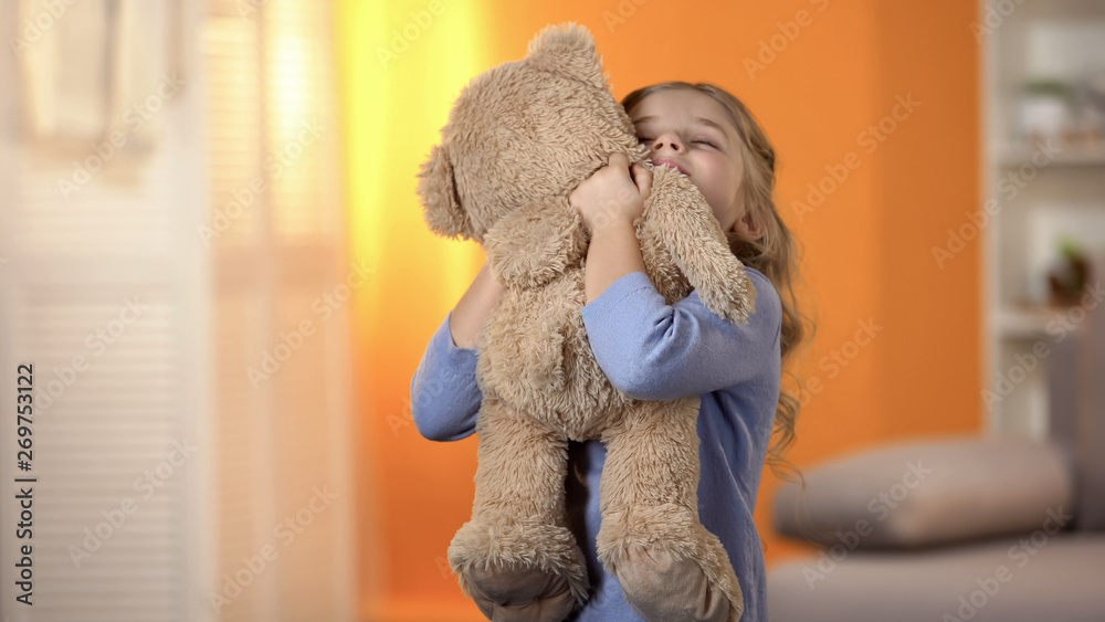 Cute little girl hugging teddy bear, favorite toy, happy childhood, best present - obrazy, fototapety, plakaty 