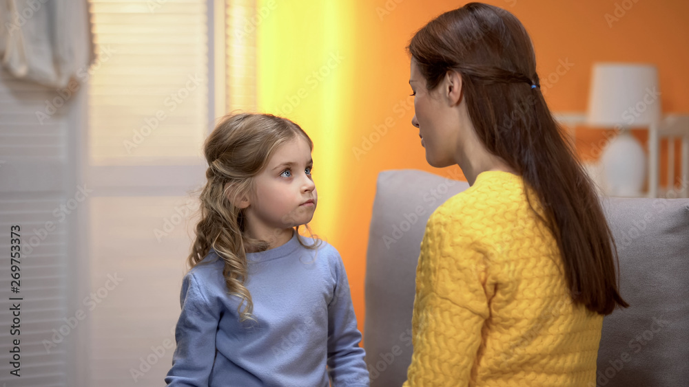 Little girl carefully listening to psychologist, kid crisis prevention childcare - obrazy, fototapety, plakaty 