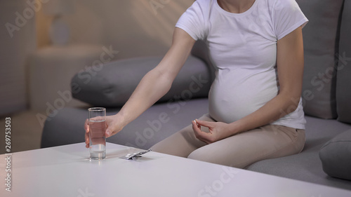 Expectant woman taking medicine  pregnant pyelonephritis treatment  healthcare