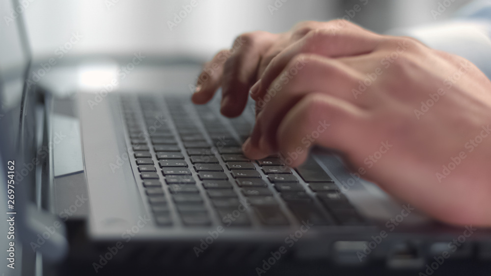 Businessman hands typing on laptop, pressing buttons on keyboard, internet