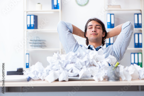 Businessman rejecting new ideas with lots of papers