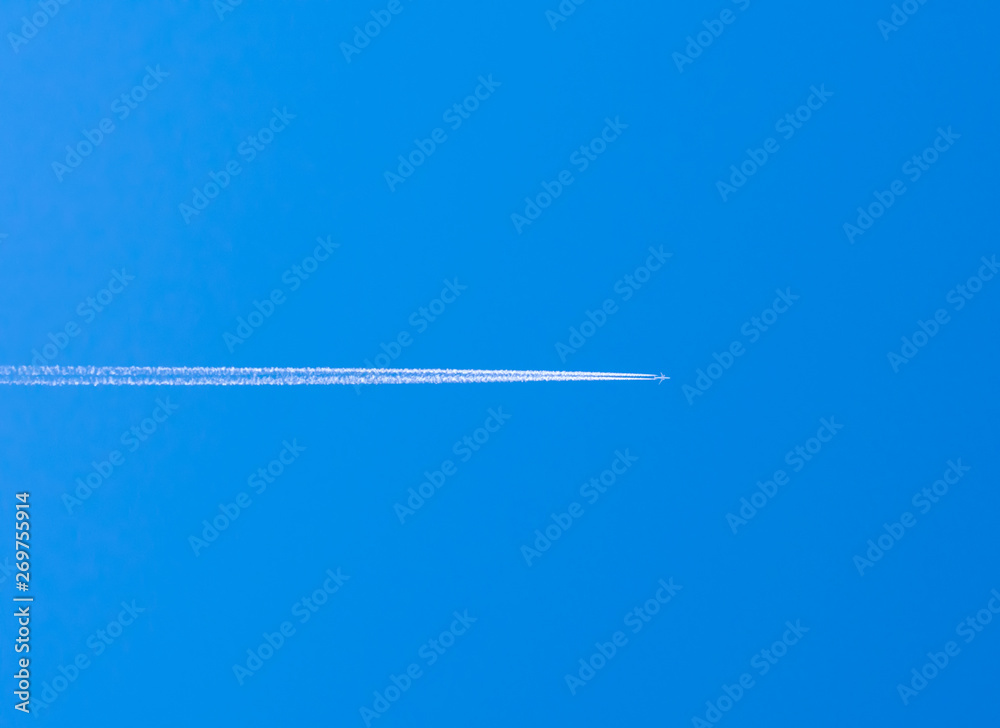 airplane contrail against clear blue sky with copy space airplane contrail against clear blue sky with copy space