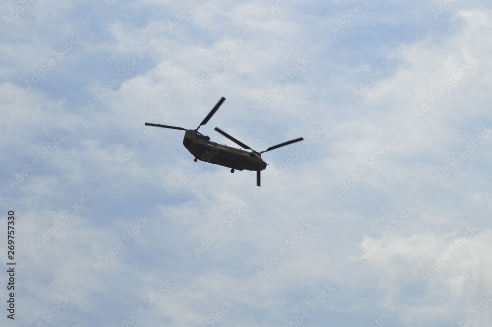 Boeing CH-47 Chinook helicopter in flight over clouds Boeing CH-47 Chinook helicopter in flight over clouds