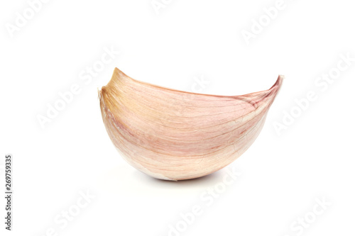 Single clove of garlic isolated on white background in close-up.