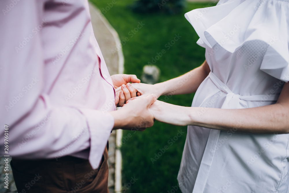 The bride and groom wear wedding rings. hands of newlyweds with wedding rings. Wedding ceremony. The bride and groom wear wedding rings. hands of newlyweds with wedding rings. Wedding ceremony.