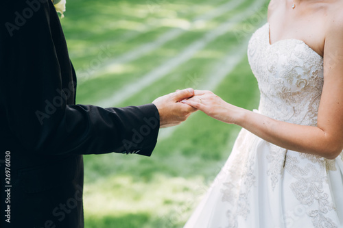 The bride and groom wear wedding rings. hands of newlyweds with wedding rings. Wedding ceremony. © Stanislav