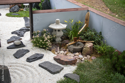Canvas Print the Japanese garden with ikebana, sand and rake