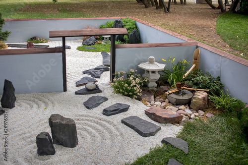 Photography the Japanese garden with ikebana, sand and rake