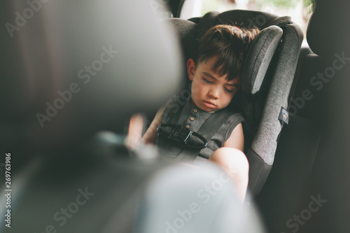 A boy sleeping in the car photo
