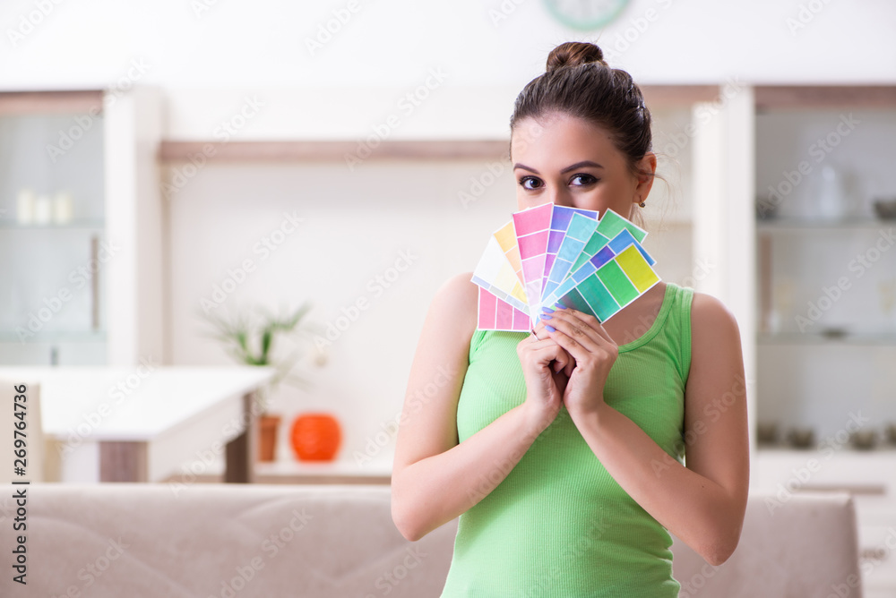 Young beautiful woman doing renovation at home Young beautiful woman doing renovation at home