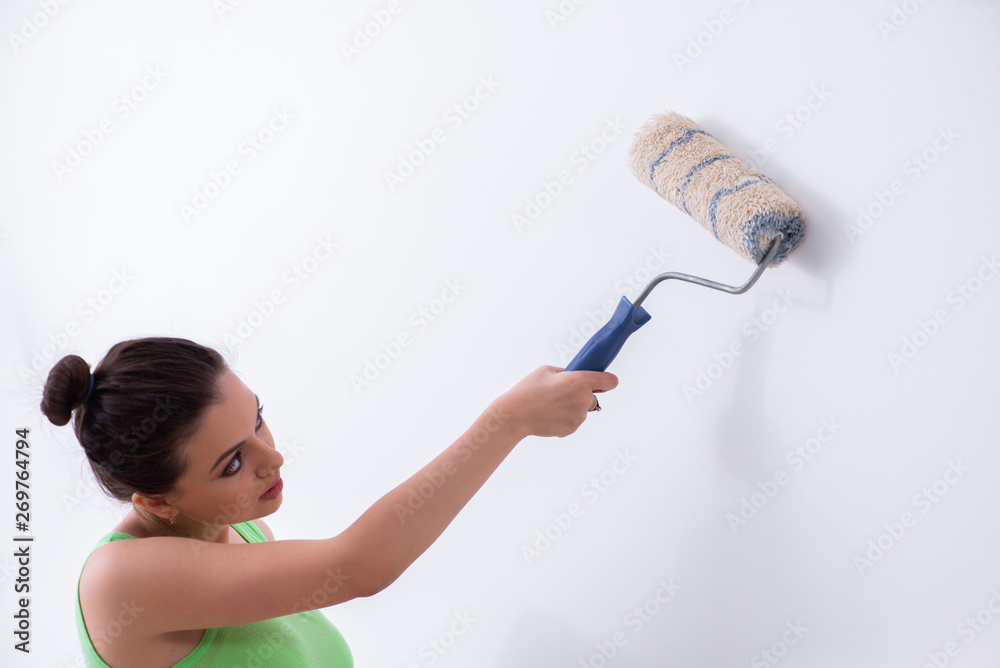 Young beautiful woman doing renovation at home Young beautiful woman doing renovation at home
