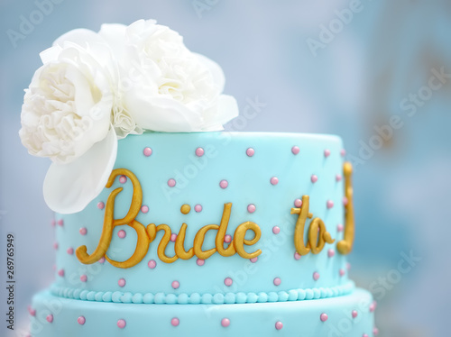 Traditional anniversary/wedding multi-layer cake. Beautiful delicious sweet dessert decorated with flowers