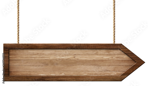 Simple wooden arrow signpost made of natural wood and with dark frame hanging on ropes photo