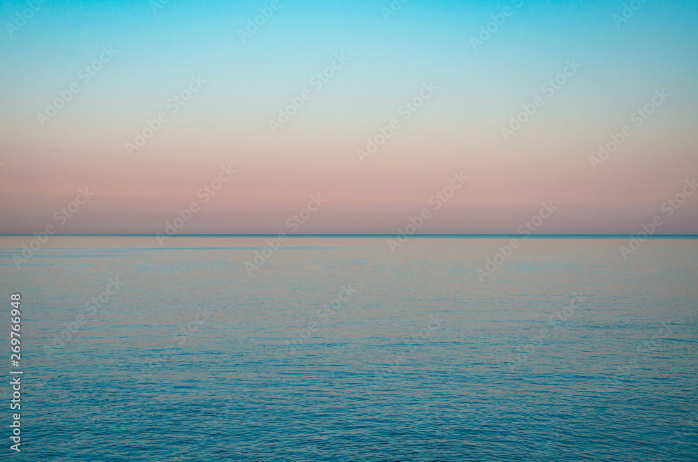 Seascape, view of sea horizon and colorful sky at sunset