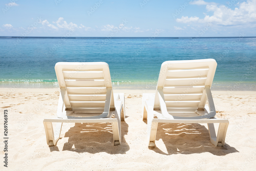 White Deck Chair In Front Of Sea At Beach