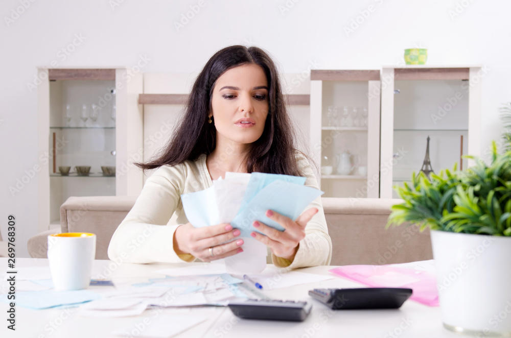 Young woman with receipts in budget planning concept Young woman with receipts in budget planning concept