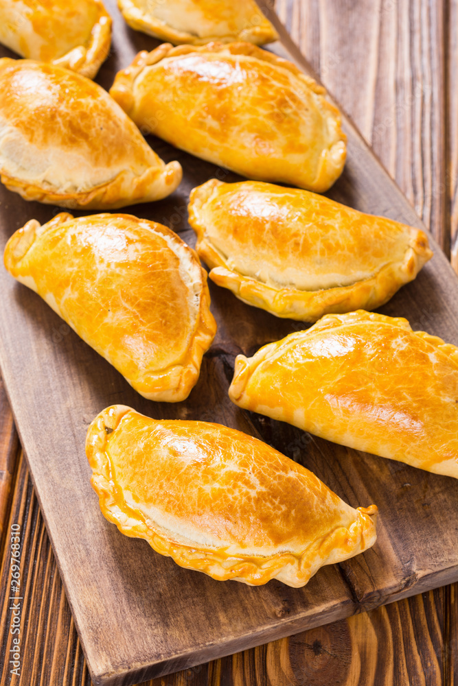 Latin American baked beef empanadas with sauce